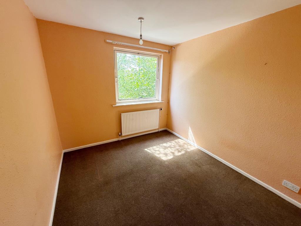 Lot: 109 - FIRST AND SECOND FLOOR THREE-BEDROOM MAISONETTE - Bedroom with painted walls and dark carpet